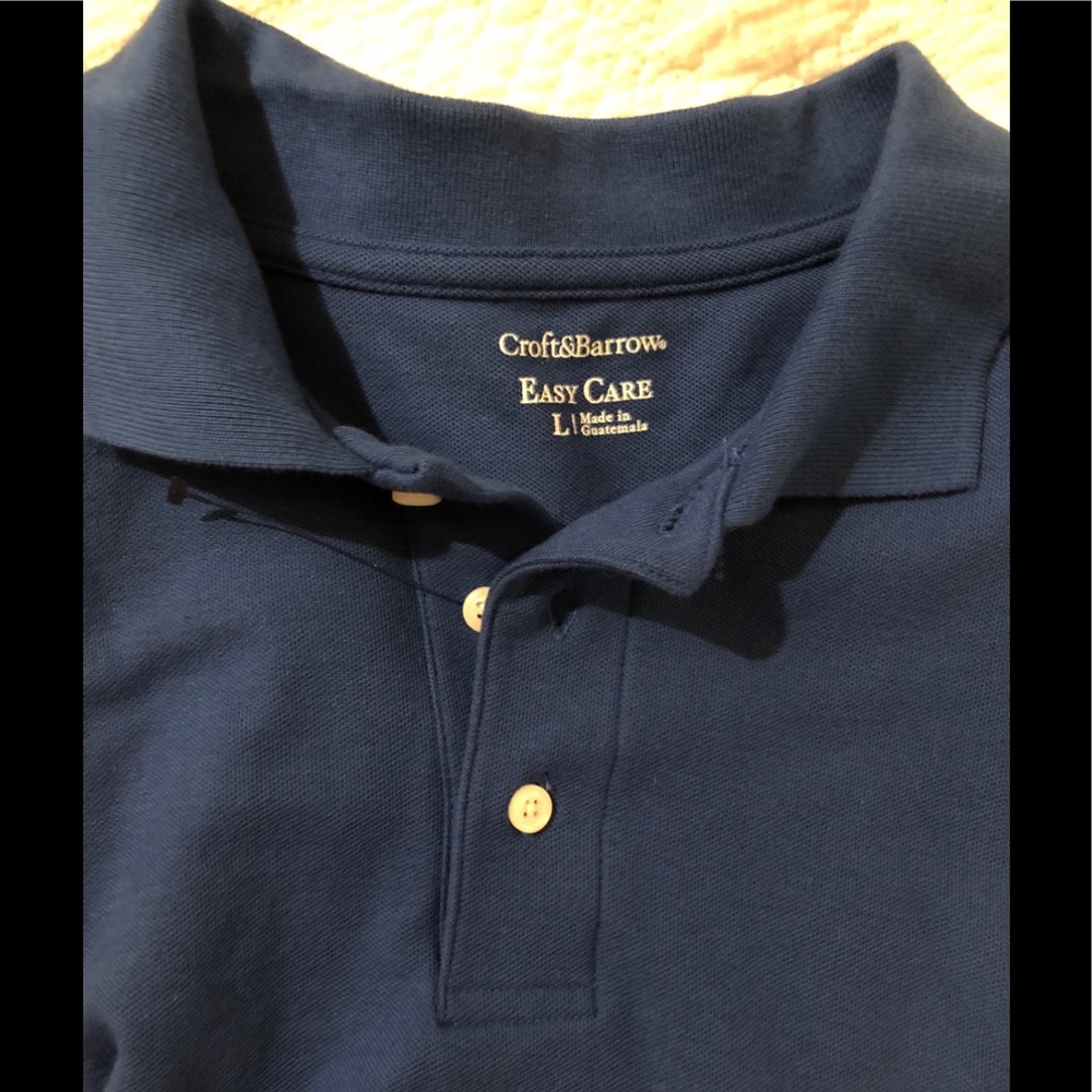 NWOT men’s large blue Easy Care polo shirt.
